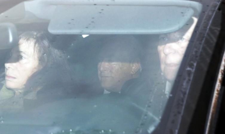 Former IMF head Dominique Strauss-Kahn (C) rides in the backseat of a car as he arrives to attend the trial in the so-called Former IMF head Dominique Strauss-Kahn (C)