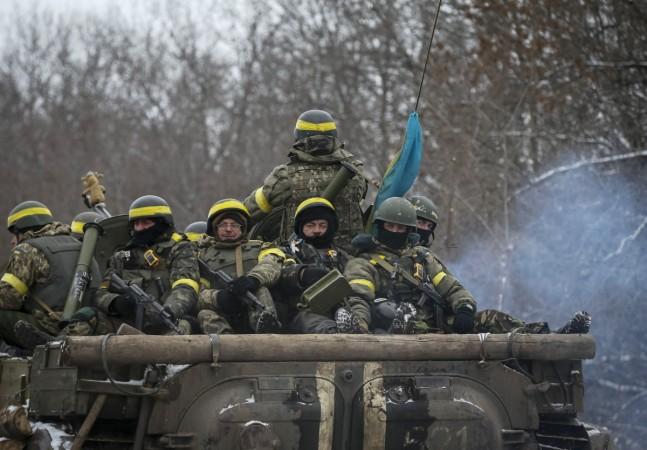 Members of the Ukrainian armed forces ride on an armoured personnel carrier (APC) near Debaltseve, eastern Ukraine, February 10, 2015. Members of the Ukrainian armed forces ride on an armoured personnel carrier (APC) near Debaltseve, eastern Ukraine, February 10, 2015.