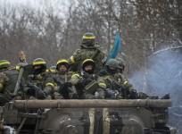 Members of the Ukrainian armed forces ride on an armoured personnel carrier (APC) near Debaltseve, eastern Ukraine, February 10, 2015.