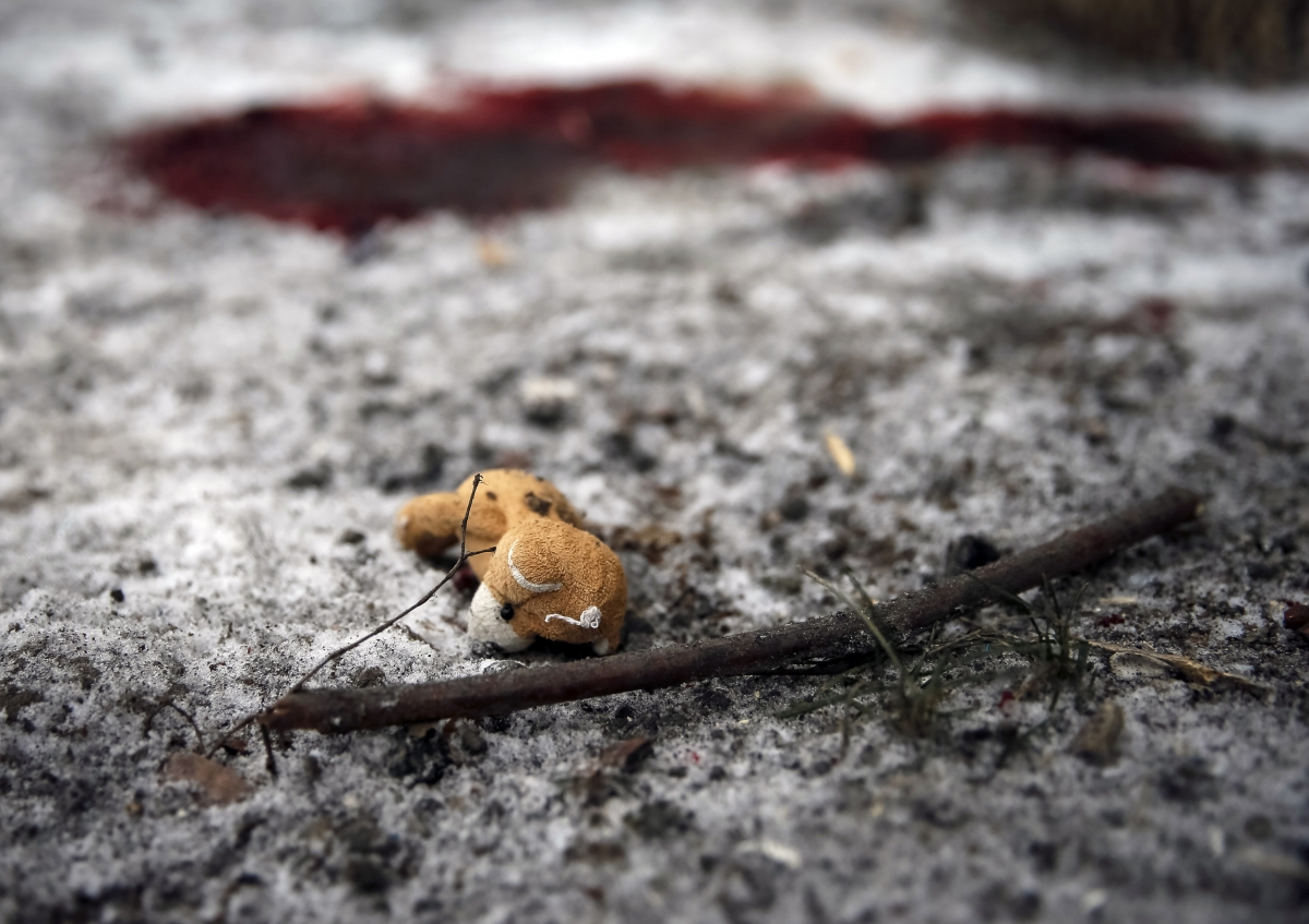 A teddy bear is seen by a puddle of blood at the site of recent shelling in the residential sector in the town of Kramatorsk, eastern Ukraine February 10, 2015. Ukraine