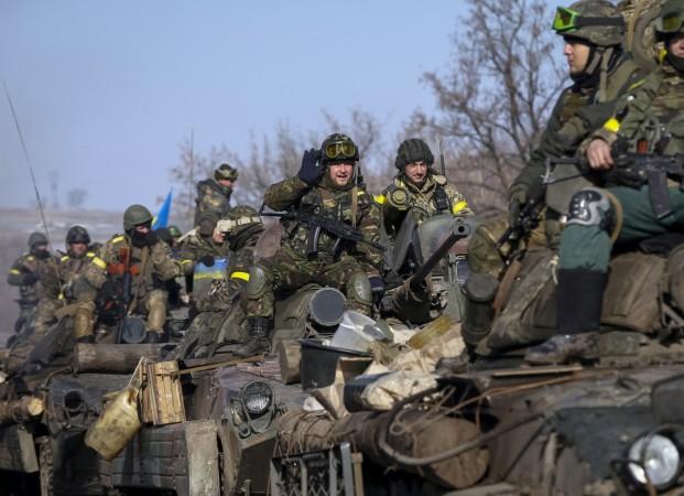 Members of the Ukrainian armed forces ride on armoured personnel carriers (APC) near Debaltseve, eastern Ukraine, February 12, 2015. Members of the Ukrainian armed forces ride on armoured personnel carriers (APC) near Debaltseve, eastern Ukraine, February 12, 2015.