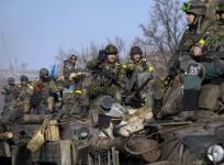 Members of the Ukrainian armed forces ride on armoured personnel carriers (APC) near Debaltseve, eastern Ukraine, February 12, 2015.
