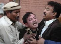 A man cries over the death of his relative, who was killed in an explosion in a Shi'ite mosque, outside a hospital in Peshawar February 13, 2015.
