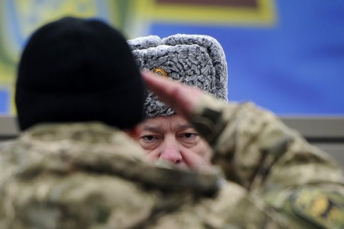 Ukraine's President Petro Poroshenko attends a ceremony to hand over certificates for new and upgraded military equipment to the army at the training center of the Ukrainian National Guard outside Kiev February 13, 2015. Ukrainian president has accused Russia of increasing their offensive against Kiev troops a day ahead of what a ceasefire.