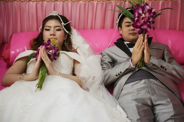 Bride and Groom Exchange Wedding Vows in Coffins in Bangkok.