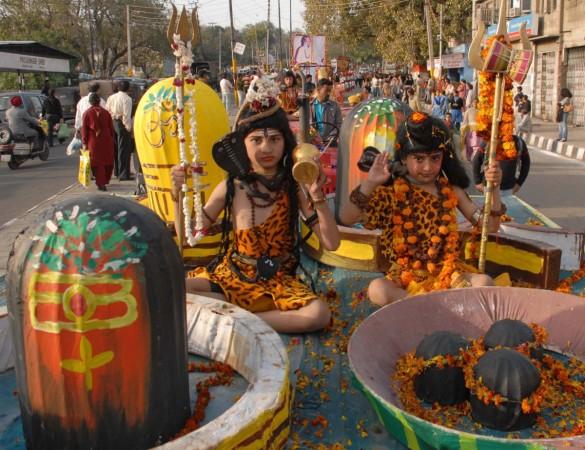 Wish Happy Maha Shivratri 2015 with these quotes, sayings, messages and wishes both in English and Hindi languages. (Photo Description: Hindu devotees dressed as Lord Shiva take part in a religious procession ahead of Wish Happy Maha Shivratri 2015 with these quotes, sayings, messages and wishes both in English and Hindi languages.