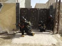 Members of the Iraqi security forces patrol an area near the borders between Karbala Province and Anbar Province