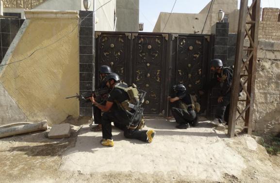 Members of the Iraqi security forces patrol an area near the borders between Karbala Province and Anbar Province