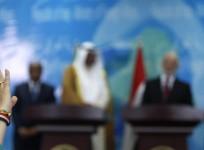 A journalist raises her hand to ask a question during a news conference in Baghdad