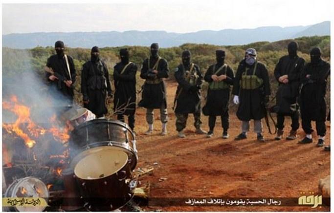 Isis fighters in Libya have released pictures where they have burnt musical instruments . Isis fighters in Libya have released pictures where they have burnt musical instruments .