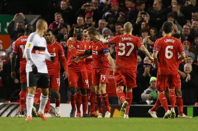 Mario Balotelli celebrates with team mates after scoring the first goal for Liverpool from the penalty spot Mario Balotelli