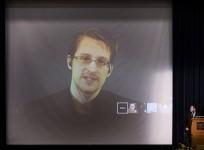 Former U.S. National Security Agency contractor Edward Snowden appears live via video with journalist Glenn Greenwald during a student organized world affairs conference at the Upper Canada College private high school in Toronto, February 2, 2015.