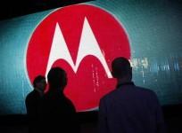 Visitors look at a video display at the Motorola booth