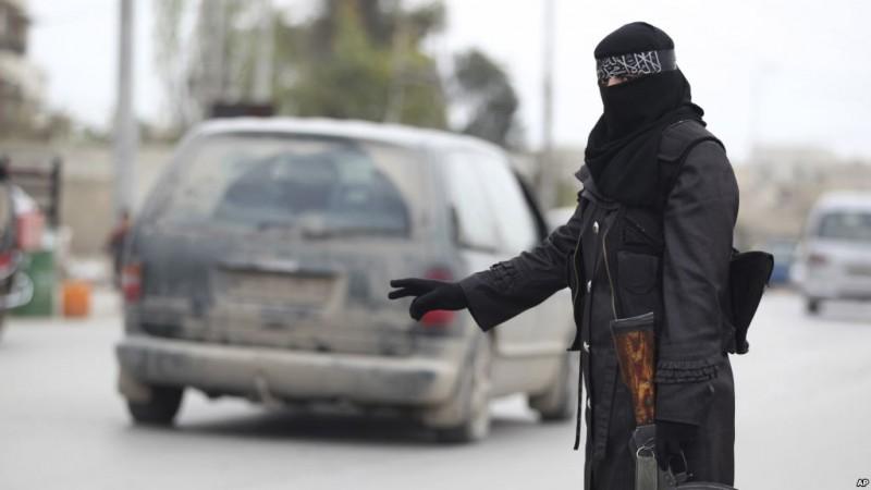 A lady guard working for a Islamist radical group stands at a check point in Syria