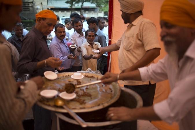 Sikh devotees distribute free food.