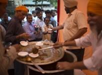 Sikh devotees distribute free food.