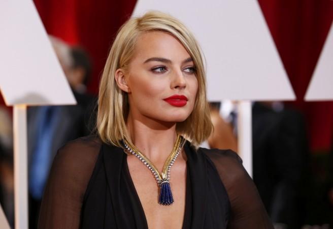 Actress Margot Robbie wears a Saint Laurent dress along with Van Cleef & Arpels jewelry at the 87th Academy Awards in Hollywood Oscars 2015