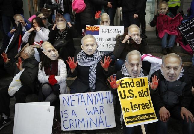 Anti-Israel demonstrators led by the protest group Code Pink wear masks of Israeli Prime Benjamin Netanyahu as they sit at the entrance to the American Israel Public Affairs Committee (AIPAC) policy conference at the Washington Convention Center in Washington, March 1, 2015. Anti-Israel demonstrators led by the protest group Code Pink wear masks of Israeli Prime Benjamin Netanyahu as they sit at the entrance to the American Israel Public Affairs Committee (AIPAC) policy conference at the Washington Convention Center in Washin