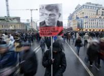 A man holds a poster of Kremlin critic Boris Nemtsov, who was shot dead on Friday night, during a march to commemorate him in central Moscow March 1, 2015.