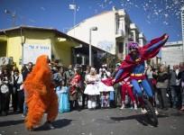 Performers wearing costumes take part in a parade ahead of the Jewish holiday of Purim outside the Bialik Rogozin school in Tel Aviv March 3, 2015.