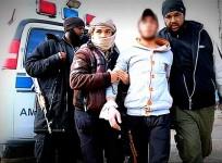 Isis fighters escort the young man accused of stealing a motorbike in Raqqa.