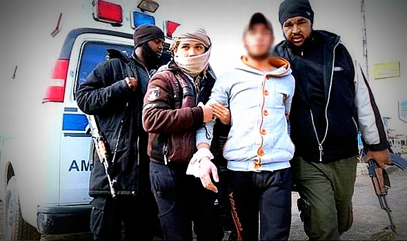 Isis fighters escort the young man accused of stealing a motorbike in Raqqa.