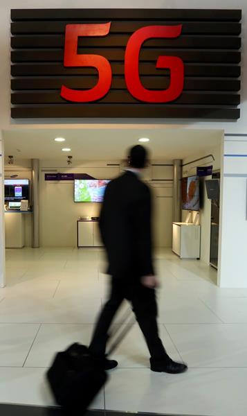 A man walks past a stand while attending the Mobile World Congress in Barcelona March 2, 2015. Ninety thousand executives, marketers and reporters gather in Barcelona this week for the telecom operators Mobile World Congress, the largest annual trade show