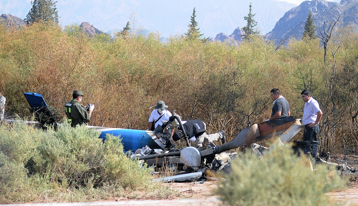 Investigators work next to the charred wreckage of the two helicopters which collided in the region of Villa Castelli, in the Argentine province of La Rioja. Argentina Helicopter Crash
