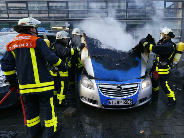 Fireworkers extinguish police vehicles