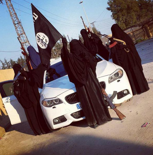 wives and daughters of dead Australian Isis terrorists Suhan Rahman and Mahmoud Abdullatif pose with AK 47 besides a BMW M5. wives and daughters of dead Australian Isis terrorists Suhan Rahman and Mahmoud Abdullatif pose with AK 47 besides a BMW M5.