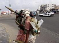 Militia men secure a street leading to the airport during clashes in Yemen's southern port city of Aden March 19, 2015