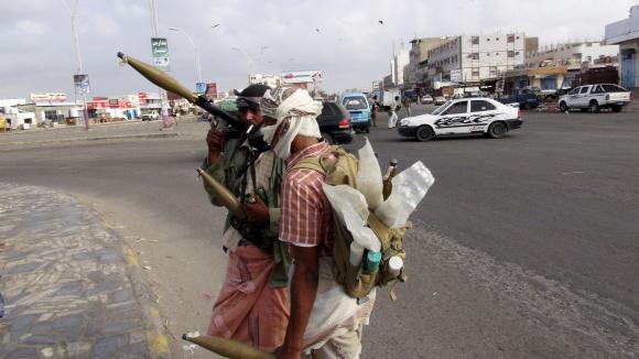 Militia men secure a street leading to the airport during clashes in Yemen's southern port city of Aden March 19, 2015