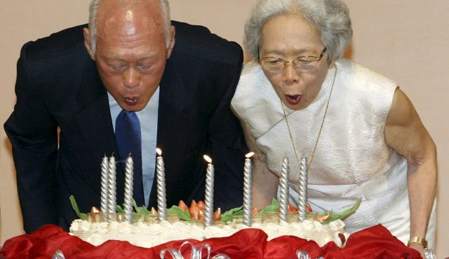 Lee Kuan Yew, architect of modern Singapore, and his wife Kwa Geok Choo (R) blow out candles on his birthday cake as he celebrates his 80th birthday in Singapore in this September 16, 2003 file photo