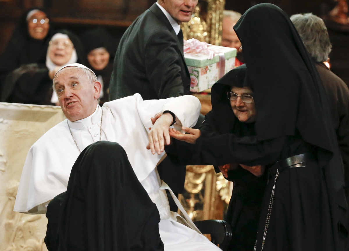 Pope Francis reacts as he is greeted by cloistered nuns at the Duomo during his pastoral visit in Naples. Pope Francis in Naples