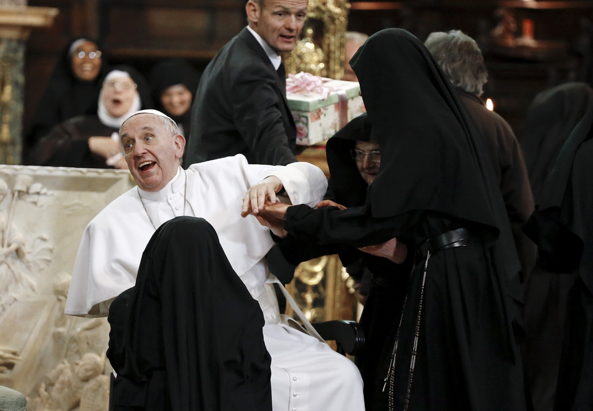 Pope Francis reacts as is greeted by cloistered nuns at the Duomo during his pastoral visit in Naples. Pope Francis in Naples