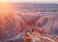 Vehicles drive during sunrise in the Taiga area along the M54 Krasnoyarsk – Mongolia highway, with the air temperature at about – 27 degrees C (-16.6 degrees F), some 120 km (75 mi) south of Russia's Siberian city of Krasnoyarsk, on December 14, 2011.