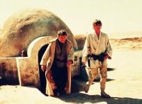 Luke Skywalker pictured with his uncle coming out of their house in 1977's Star Wars