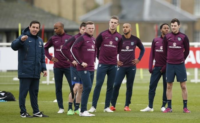 England coach Gary Neville gives instructions to (From L-R) Fabian Delph, James Milner, Wayne Rooney, Jordan Henderson, Theo Walcott, Raheem Sterling and Ryan Mason during a training session England