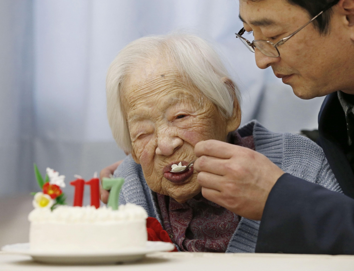 Japanese Misao Okawa, the world's oldest living person, is helped to eat her birthday cake as she celebrates her 117th birthday at an elder care facility in Osaka, western Japan in this photo taken by Kyodo March 5, 2015. oldest person