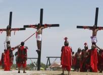 Penitents hang on wooden crosses during the re-enactment of the crucifixion of Jesus Christ on Good Friday in San Fernando, Pampanga in northern Philippines April 18, 2014. Nearly 20 Filipinos and a Danish filmmaker were nailed to crosses to re-enact the