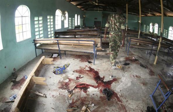 A Kenyan policeman walks inside the African Inland Church after an attack in Kenya's northern town of Garissa July 1, 2012