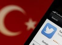 A Twitter logo on an iPhone display is pictured next to a Turkish flag in this photo illustration taken in Istanbul March 21, 2014
