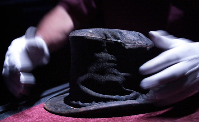 An exhibition displays a silk top hat rescued from the sunken Titanic in London. The Titanic Remains