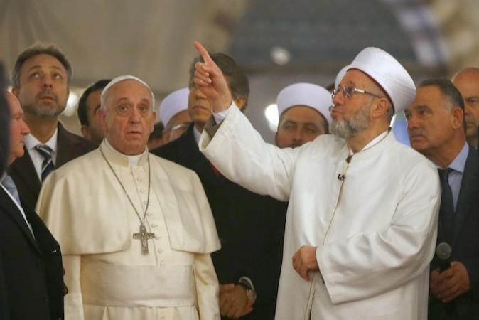 Pope Francis listens to Rahmi Yaran, Mufti of Istanbul (right) during a visit to Hagia Sophia in Istanbul