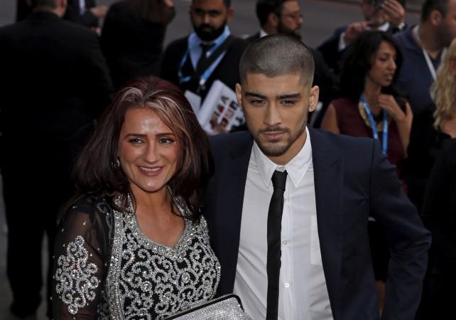 Former One Direction member Zayn Malik (R) and his mother Trishia (L) arrive at the fifth annual Asian Awards in the Grosvenor House Hotel, London 17 April 2015. asian awards