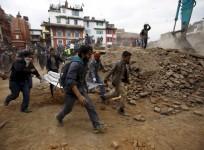 People carry the body of a victim on a stretcher, which was trapped in the debris after an earthquake hit, in Kathmandu, Nepal April 25, 2015.