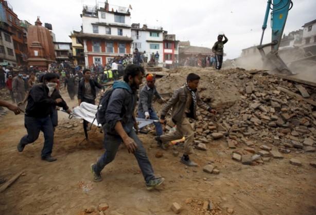 People carry the body of a victim on a stretcher, which was trapped in the debris after an earthquake hit, in Kathmandu, Nepal April 25, 2015. People carry the body of a victim on a stretcher, which was trapped in the debris after an earthquake hit, in Kathmandu, Nepal April 25, 2015.