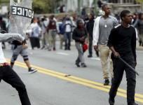 Demonstrators throw rocks at Baltimore police during clashes in Baltimore, Maryland April 27, 2015.