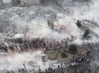 Protesters run as riot police fire teargas during a protest at Taksim Square in Istanbul June 11, 2013