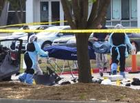 Personnel remove the bodies of two gunmen who opened fire on a security officer on Sunday outside a venue in Dallas, Texas.